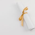 Rolled paper tied with a gold ribbon symbolizing achievements and celebrations.