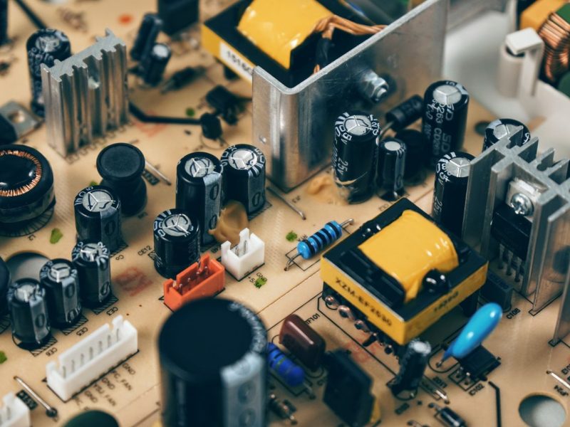 Detailed shot of capacitors and resistors on a circuit board, showcasing modern technology.